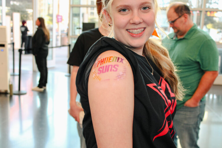 Airbrush temporary tattoo on a woman's arm at an Arizona party
