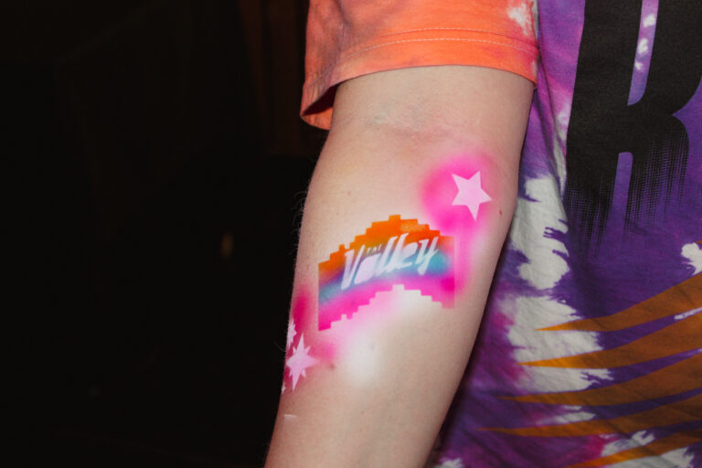 Airbrush temporary tattoo on a woman's forearm at an Arizona party