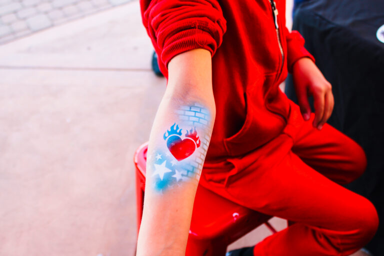Airbrush temporary tattoo on a woman's forearm at an Arizona party