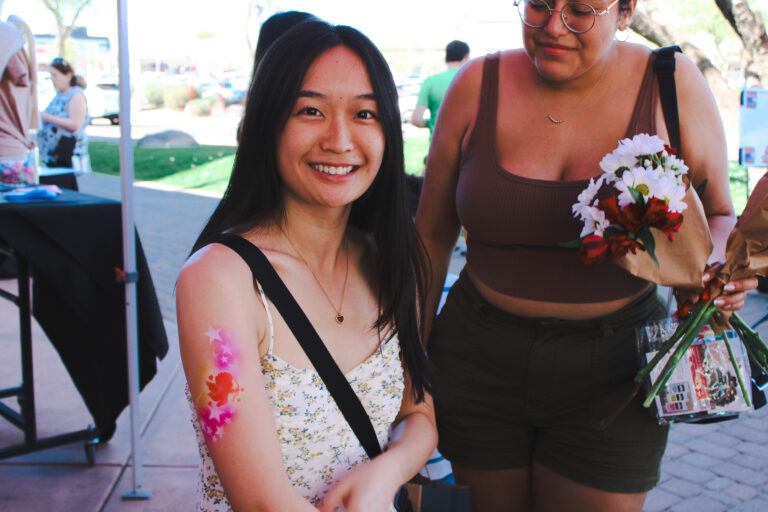 Airbrush temporary tattoo on a woman's forearm at an Arizona party