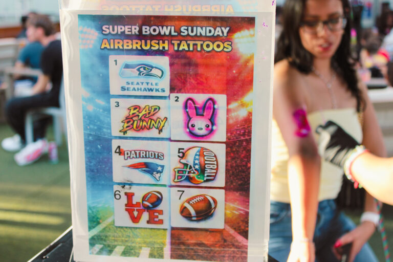 Airbrush temporary tattoo on a woman's forearm at an Arizona party