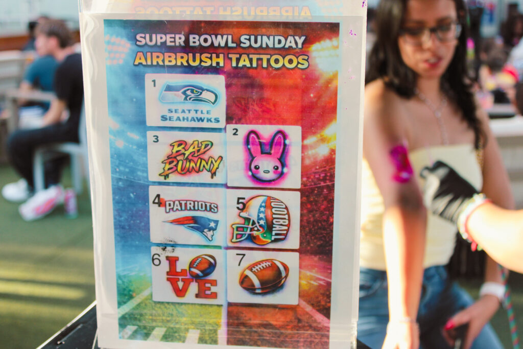 Airbrush temporary tattoo on a woman's forearm at an Arizona party