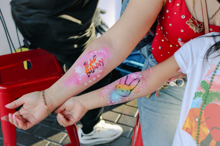 Airbrush temporary tattoo on a woman's forearm at an Arizona party
