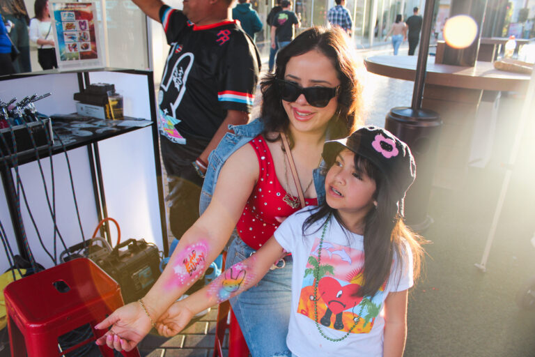 Airbrush temporary tattoo on a woman's forearm at an Arizona party