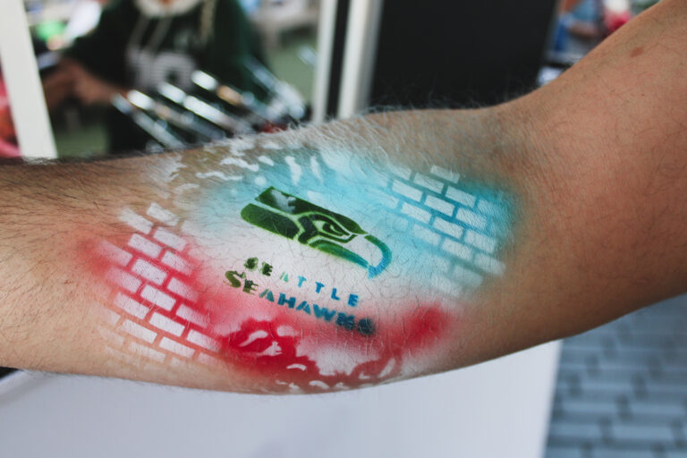 Airbrush temporary tattoo on a woman's forearm at an Arizona party